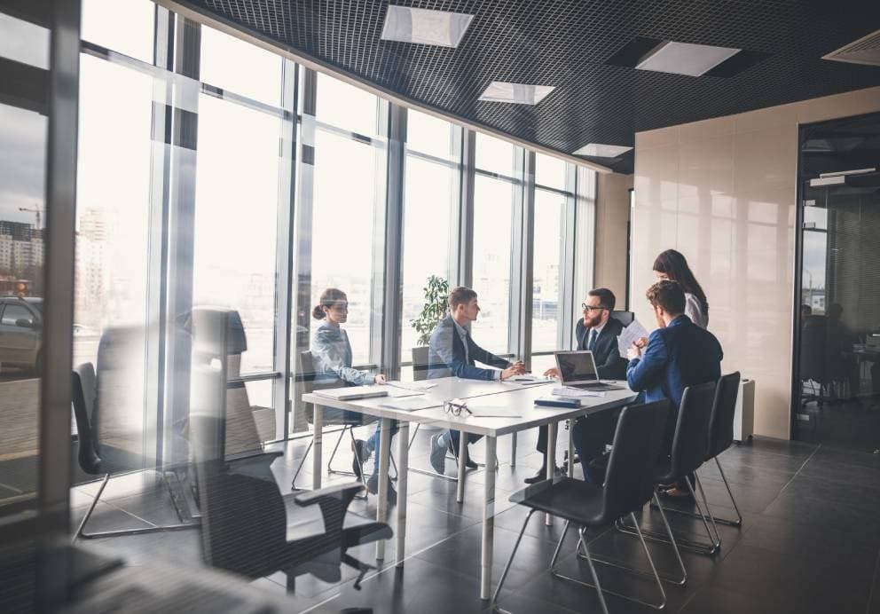 Fortis team collaborating in a bright, modern workspace.